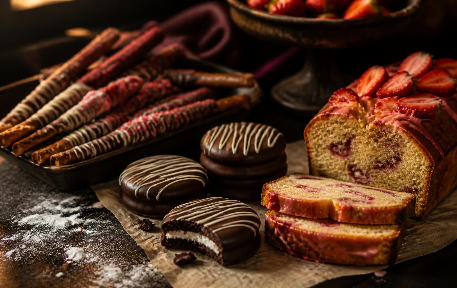 Assortment of chocolate dipped cookies, pretzel rods and pound cake